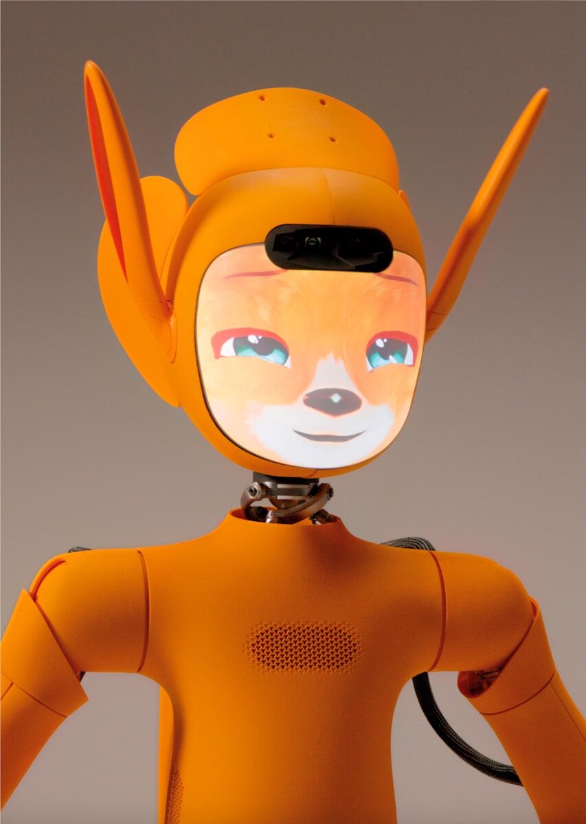 An orange robot with a fox-like face on screen.